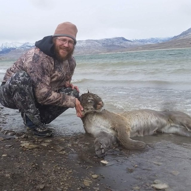 chris-hancock-with-dead-mountain-lion-found-in-water