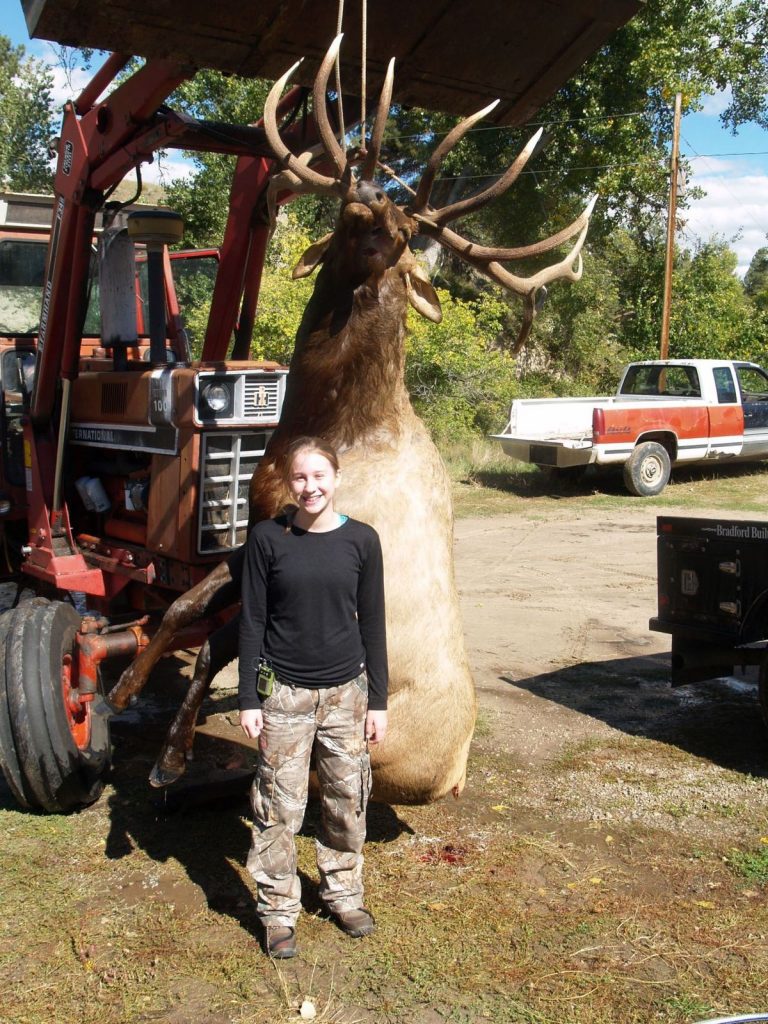 hannah-helmer-standing-with-state-record-elk-hanging