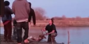 young-man-holds-deer-head-after-shoving-it-into-the-ground