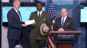 sec-zinke-recieving-check-from-spicer